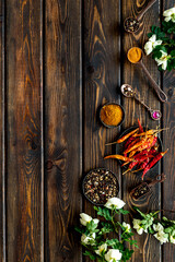 Hot spices and aromatic herbswith cooking utensils overhead