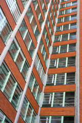 Facade of a renovated historic office building with many windows. Minimalism and perspective