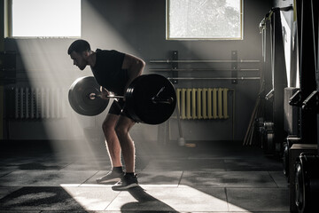 Man Do Exercise on Arms With Dumbbell .