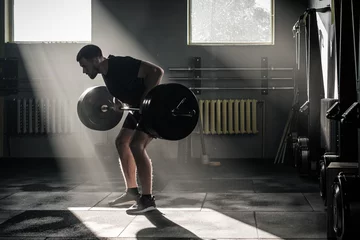 Man Do Exercise on Arms With Dumbbell . © Nejron Photo