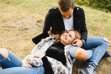 Romantic young couple in love relaxing outdoors in park