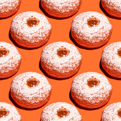 Seamless pattern with sufganiya for Jewish holiday Hanukkah on orange background.