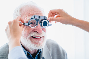 Close up picture of senior male patient with cheerful smile during ophthalmic vision check up