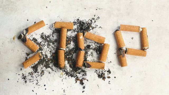 Close-up of cigarettes butts on white background. Stop smoking.