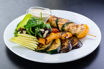 chicken kebab on a skewer and grilled vegetables