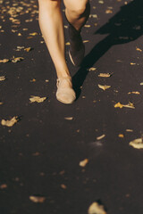 A beautiful woman with curly dark hair in a red dress walks through the autumn city. Autumn mood,...