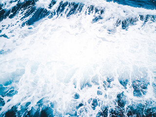 White bubble of wave caused by the boat running through the ocean.