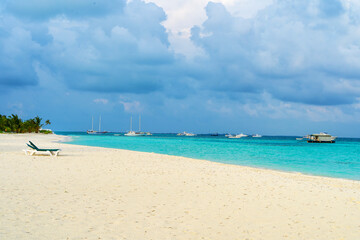 Lounge chairs on a beautiful tropical beach at Maldives