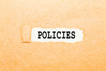 a word POLICIES on a torn piece of paper, a business concept