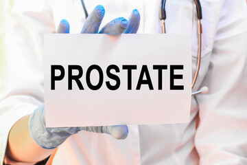 Doctor holding a card with text PROSTATE, medical concept