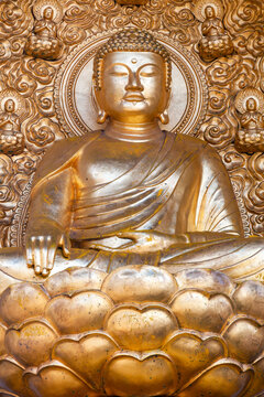 London, UK, February 26, 2012 :  Gilded bronze gold Buddha statue one of four which are part of the Buddhist Peace Pagoda in Battersea Park