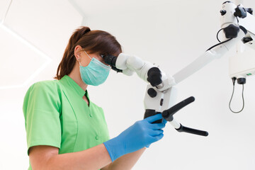 Dentist doctor using dental microscope