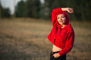 portrait of a beautiful young female with red hair in a red jacket