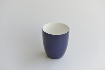 Blue and white porcelain cup isolated on white background. Simplicity. Cup with shadows