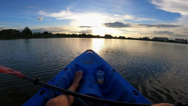 Kayaking during a beautiful sunset in Thailand. Medium shot of the kayak