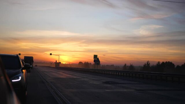 Family trip. The family is driving on the highway. Sunset time