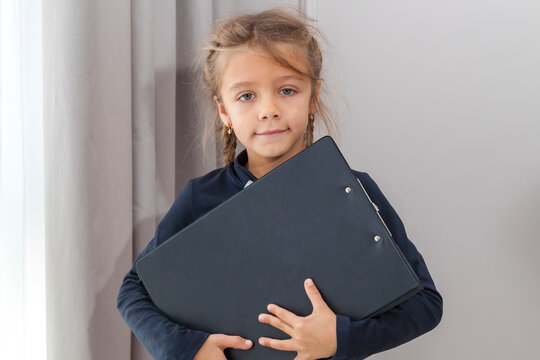 Happy Small Girl Hold File Paper Folder. Office Life. Schoolgirl Has Paperwork Homework. Back To School. Study Lesson. Knowledge And Education.