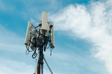 Telecommunication tower for 5G network, on blue sky background, technology photo conceptual.