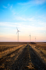 Windmills for electric power production at sunset