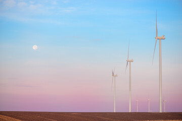Windmills for electric power production at sunset