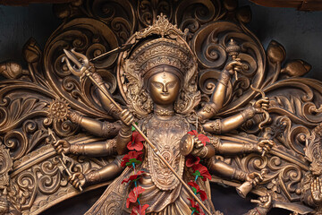 Idol of Goddess Devi Durga at a decorated puja pandal in Kolkata, West Bengal, India. Durga Puja is a famous and major religious festival of Hinduism that is celebrated throughout the world.