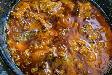 home made making spicy chicken in indian style close view  looking awesome in frying pan.
