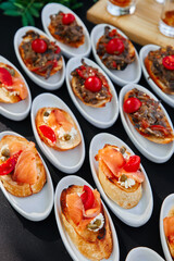 Outdoor catering banquet in summer. Table with snacks and canapes  at a summer banquet