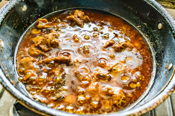 home made making spicy chicken in indian style close view  looking awesome in frying pan.
