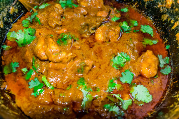 home made making spicy chicken in indian style close view  looking awesome in frying pan.
