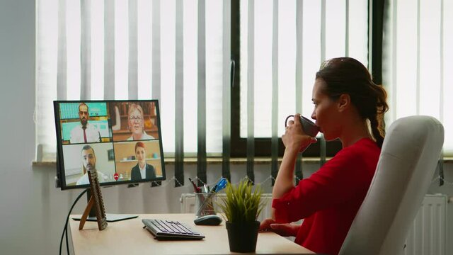 Business woman discussing on webcam with partners sitting in modern office. Freelancer working with remotely team chatting having virtual online conference, meeting, webinar using internet technology