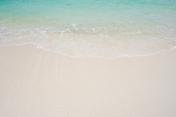 Fototapeta na wymiar Sandy beach with soft ocean wave
