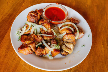 Pork kebab with sauce on a plate