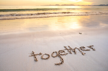 the word together written on the sand beach