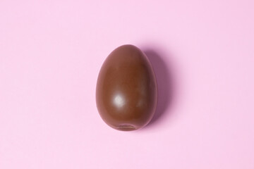 Chocolate egg on a pink background. Chocolate product