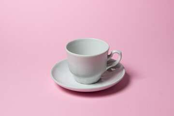 Coffee cup on a pink background. Coffee cup and saucer.