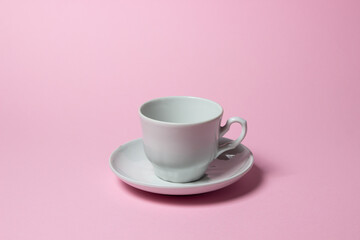 Coffee cup on a pink background. Coffee cup and saucer.