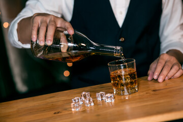 Barman pouring whiskey whiskey glass beautiful night