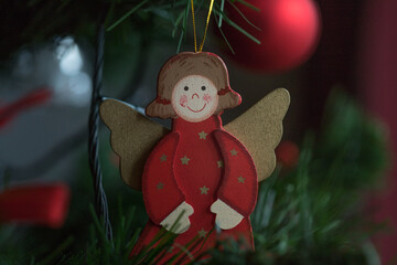 A wooden angel on a Christmas tree