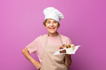 mature beautiful old woman smiling happily with a hand on hip and confident, positive, proud and friendly attitude