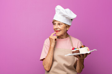 mature beautiful old woman smiling happily and daydreaming or doubting, looking to the side