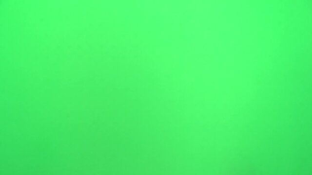 Handshake of male hands on a green background or chromakey