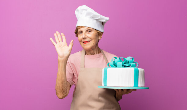 mature beautiful old woman smiling happily and cheerfully, waving hand, welcoming and greeting you, or saying goodbye - Powered by Adobe