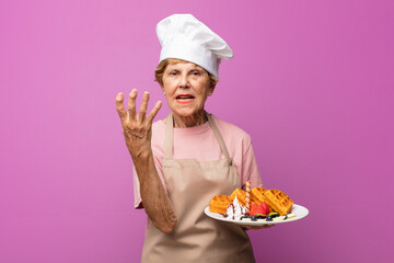 mature beautiful old woman looking angry, annoyed and frustrated screaming wtf or what‚Äôs...