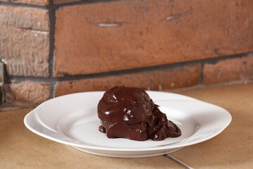 Choux pastry ball with custard filling and chocolate sauce icing