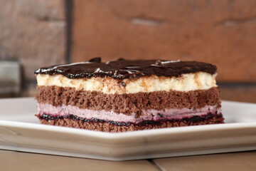 Layer cake with fruit and cream fillings decorated chocolate icing