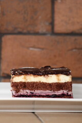 Layer cake with fruit and cream fillings decorated chocolate icing