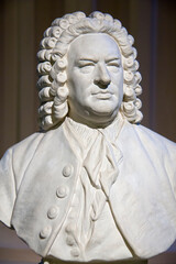 Vertical view of white bust of Johann Sebastian Bach (1685-1750), German baroque composer and musician, considered one of the greatest composers of all time - obrazy, fototapety, plakaty