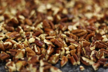 Crushed pecan nuts on granite surface