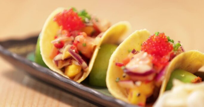 Colorful Sushi In Crispy Taco Shells On A Rectangular Plate - Slow Motion Pan Right