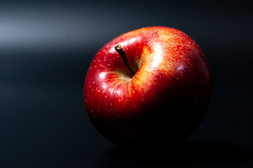 Juicy red Apple on a dark background. Bright natural color of Apple fruit.